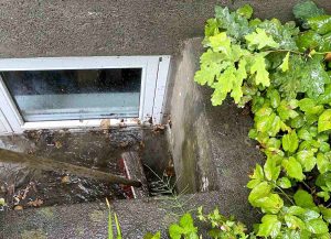 Wet basement flooded window well